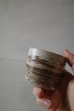 Very small warm white foraged clay cup