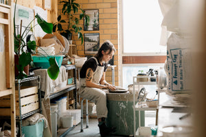 Sarah Muir-Smith, the founder of Snakebird Designs is throwing on her pottery wheel in her studio in Coburg North. She is making ceramic homewares that are intentional and beautiful.