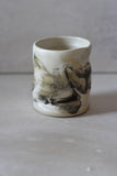 White and black painted wobble cup