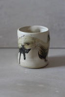White and black painted wobble cup