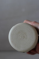 White and black painted wobble cup