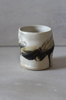 White and black painted wobble cup